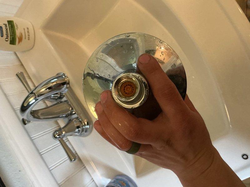 Responded to low water pressure complaints in bathroom shower and toilet at rental property. Disassembled and cleaned showerhead, removing heavy sediment buildup that was restricting water flow. Replaced toilet flapper and adjusted fill valve water level to correct slow fill time and multiple flush cycles. Recommended water treatment and filtration system evaluation to address ongoing sediment issues.