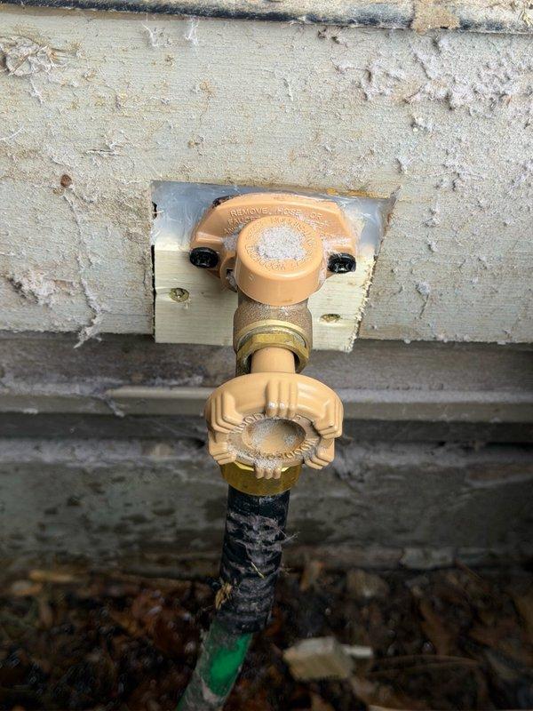 Responded to service call for leaking exterior hose bibs at property. Upon inspection, identified failed vacuum breaker on rear hose bib causing leak from top of fixture and loose packing nut on front hose bib. Replaced defective vacuum breaker assembly on rear unit and tightened packing nut on front fixture to eliminate leaks. Repositioned hose bib forward approximately two inches to improve accessibility for future maintenance requirements. Both fixtures tested and confirmed operational with no active leaks upon completion.
