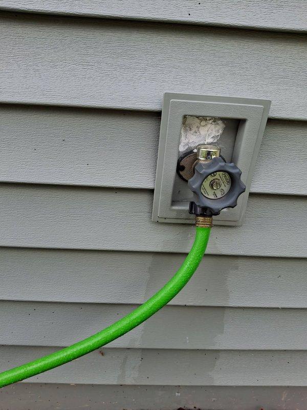 Responded to outdoor hose bibb leaking during use and behind the wall unit, an ongoing issue for approximately six years. Upon inspection, identified loose vacuum breaker as the source of the leak. Tightened and tested the vacuum breaker assembly to ensure proper seal and function. Leak successfully resolved. Additionally provided tankless water heater system information and estimate per customer request.