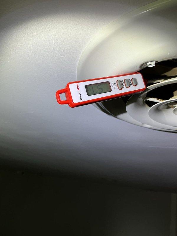 Responded to no cooling complaint on 20+ year old air conditioning system that was frozen solid. Upon arrival, customer had already thawed coils per initial instructions to shut down compressor and run fan only. Verified refrigerant charge levels were within acceptable range. Inspected MERV 11 filter in basement, found minimal restriction. System was maintaining temperature setpoint at time of inspection. Discovered blower motor showing signs of oil leakage from bearings. Inspected all electrical connections and tightened loose wire nuts throughout system. Documented equipment condition with photographs showing heavily soiled blower motor assembly with significant dust and debris accumulation. Due to age of equipment and blower motor condition, recommended comfort advisor consultation for replacement options.