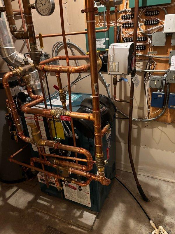 Responded to service call for inadequate hot water supply, with customer reporting only 3 minutes of warm water before turning cold during showers and dishwashing. Issue began following previous service visit where technician stood on top of water heater to access corner spigot, raising concerns about potential damage to internal components or thermostat from weight and vibration during pipe cutting work.

Inspected indirect water heater system in mechanical room and performed diagnostic testing by running multiple fixtures throughout the residence. Confirmed intermittent hot water delivery with water heating briefly before returning to cold temperature. Conducted thorough inspection of plumbing rough-in to identify potential crossover points between hot and cold water lines, focusing on mixing valves and tub/shower connections as probable failure locations.

Tested infrequently used basement shower fixtures and identified significant air pressure imbalance in shower located across fro