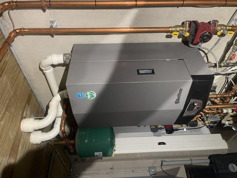 Responded to service call for boiler ignition issues that had been previously diagnosed with flame sensor and spark rod replacement, which did not resolve the problem. Upon inspection, discovered bird nest obstruction in vent pipe and removed debris to restore proper venting. Tested incoming propane gas pressure, found it reading 10 inches water column below manufacturer specifications of 11-14 inches. Adjusted gas pressure to 12 inches water column for optimal performance. Conducted operational testing of boiler system, which ignited successfully with one hard start noted during testing. Installed new flame sensor and spark rod as previously sold. Submitted warranty form for potential gas valve and venturi replacement if future issues arise. Additionally, performed Comfort Club maintenance service on two separate air conditioning systems located in two homes on the property, completing routine tune-up procedures on both units. All systems operational upon departure.