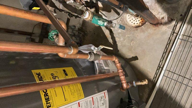 Replaced malfunctioning zone valve motor head that was stuck open, causing hot water to pass through the system during air conditioning operation. Upon installation of new motor head, discovered relay was also stuck open, causing improper zone motor operation during both heating and cooling calls. Corrected relay issue and verified proper system operation with all zones functioning correctly.