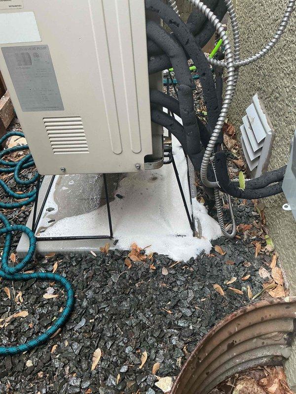Responded to water leakage issue on Mitsubishi ductless mini-split system where condensate was dripping inside from the indoor air handler. Upon inspection, found water accumulation behind the filter not draining properly, with moisture dripping through the cooling fins while system remained operational. Addressed the leaking head unit by clearing the condensate drain line obstruction. Performed thorough cleaning of the refrigerant line set and outdoor condenser unit, which exhibited significant dirt, dust, and debris accumulation across the coil fins and surfaces affecting system efficiency.
