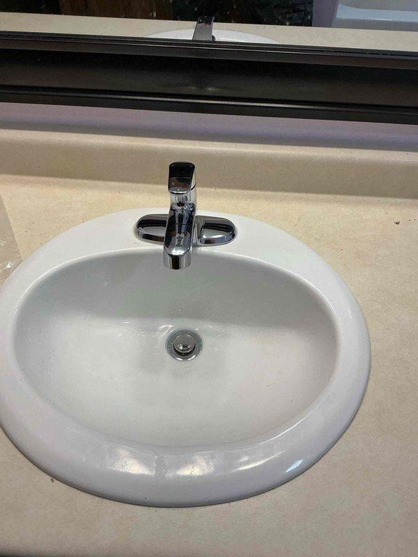 Responded to bathroom sink faucet failure. Removed and replaced deteriorated single-handle faucet assembly with new chrome single-handle unit. Installed new shut-off valve to address existing valve malfunction. Tested water flow and temperature control operation. Verified proper drain function and checked all connections for leaks. System restored to full working condition.