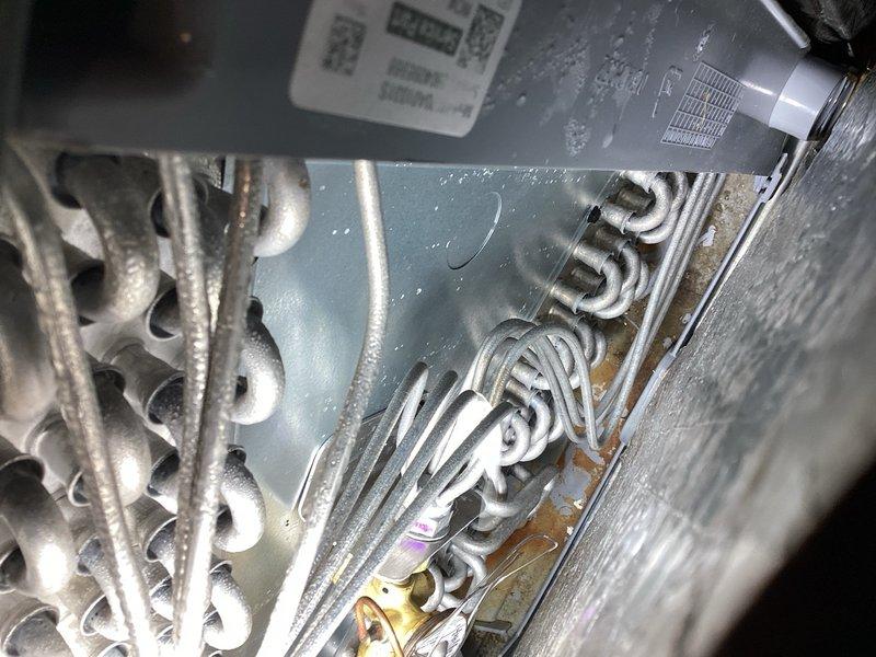 Responded to no-cooling callback following recent evaporator coil replacement. Performed comprehensive system diagnostic including condenser inspection, refrigerant level verification, thermostat and wiring checks, and attic air handler examination. Found wet switch tripped with no water present in drain pan or evidence of overflow from evaporator coil pan. Reset wet switch and restored system to normal operation. Recommended wet switch replacement to prevent future nuisance trips. System cooling properly upon departure.