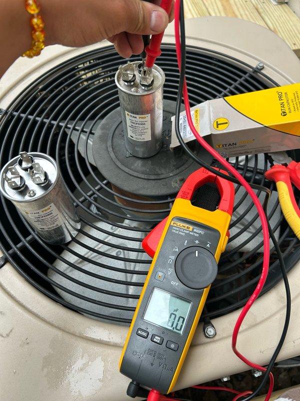 Responded to a no cooling call on an Amana air conditioning system approximately 7 years old. Upon arrival, found the outdoor condenser fan not spinning. Performed electrical diagnostics on the condenser unit and tested the dual run capacitor, which measured 0/0 MFD on both terminals, indicating complete capacitor failure. During inspection, discovered the capacitor wiring was incorrectly connected. Corrected the wiring configuration to manufacturer specifications and installed a new dual run capacitor. Cycled the system and verified proper condenser fan operation and confirmed the unit is now cooling effectively.