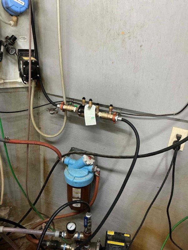 Replaced failed RPZ backflow preventer with new Watkins RPZ assembly to protect potable water supply from contamination in commercial mechanical room. Removed deteriorated existing backflow device and installed new unit with proper brass fittings, test cocks, and pressure connections per code requirements.