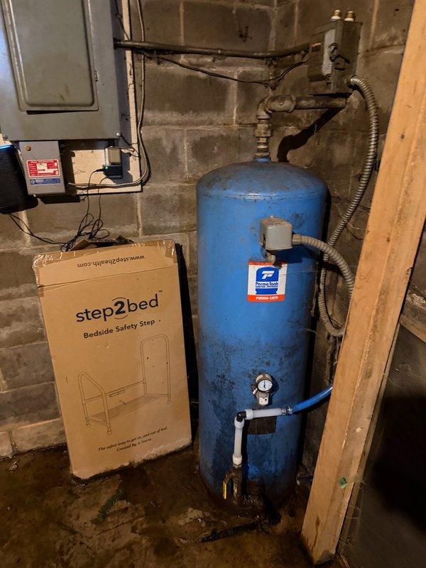 Responded to low water pressure complaint and discovered leaking pressure tank fitting causing basement flooding. Replaced failed fitting on top of pressure tank to stop active leak and restore system integrity. Assessed aging pressure tank showing significant corrosion and oxidation, along with multiple PEX line connections requiring repair. Recommended full pressure tank replacement and water repipe evaluation due to extent of system deterioration and ongoing reliability concerns.