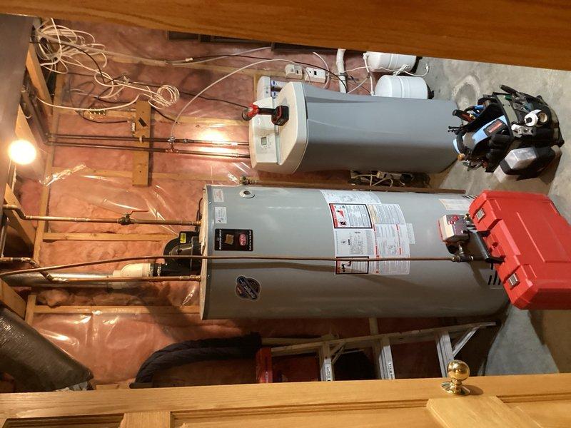 Removed humidifier water supply line from newly installed HVAC units in basement utility area. Eliminated existing 3/4" copper supply piping and prepared system for proper reconnection using two 3/4" couplings and replacement pipe section to restore main water line integrity after humidifier removal.