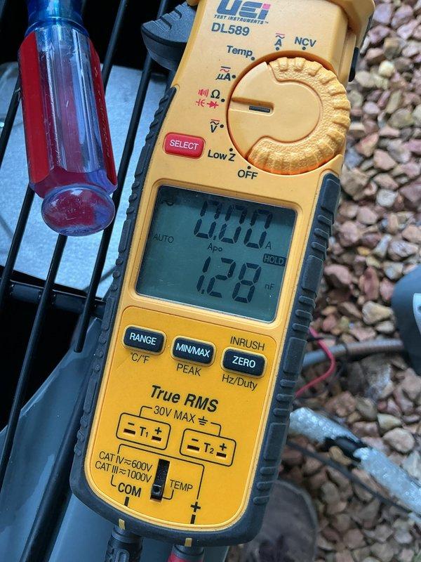 Responded to no cooling call on 13-year-old residential air conditioning system with non-operational condenser unit. Diagnosed failed dual run capacitor preventing compressor and condenser fan operation. Replaced defective dual capacitor with proper replacement, restored system to normal cooling operation, and verified amperage readings within manufacturer specifications.