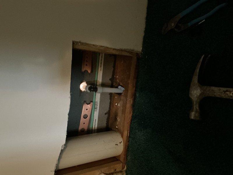 Responded to active water leak behind toilet with water supply shut off to home. Upon inspection, identified pinhole leak in copper elbow fitting within wall cavity behind toilet fixture. Removed compromised copper elbow and accessed plumbing below toilet level. Installed new PEX supply lines running from lower access point up through wall to toilet location. Installed new shut-off valve and reconnected to toilet supply line. Tested system for proper operation and verified no additional leaks present. Restored water service to home.