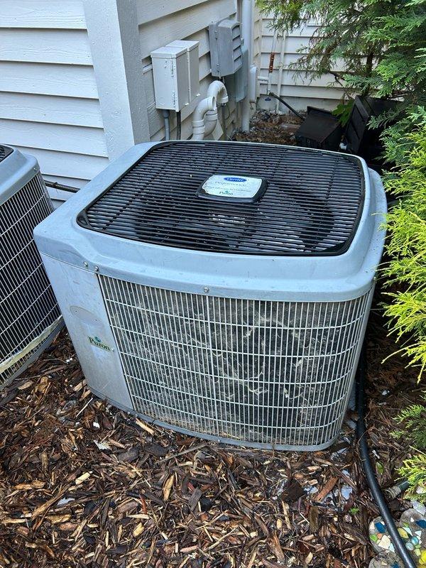 Performed diagnostic on 20+ year old dual cooling system for reported no cooling and water leakage at basement air handler with evaporator coil freezing. Inspected both outdoor condensing units and indoor equipment. Verified far end system operating with low refrigerant charge, indicating refrigerant leak present in circuit. Low charge condition causing evaporator coil to freeze, resulting in water leakage at furnace during thaw cycles when fan operates. Checked refrigerant pressures on both systems - near end system pressures within normal operating range with no signs of refrigerant loss observed. Advised limiting operation of affected far end system until leak repair and recharge completed to prevent continued coil freezing and water damage. Recommended using fan-only mode sparingly if air circulation needed.