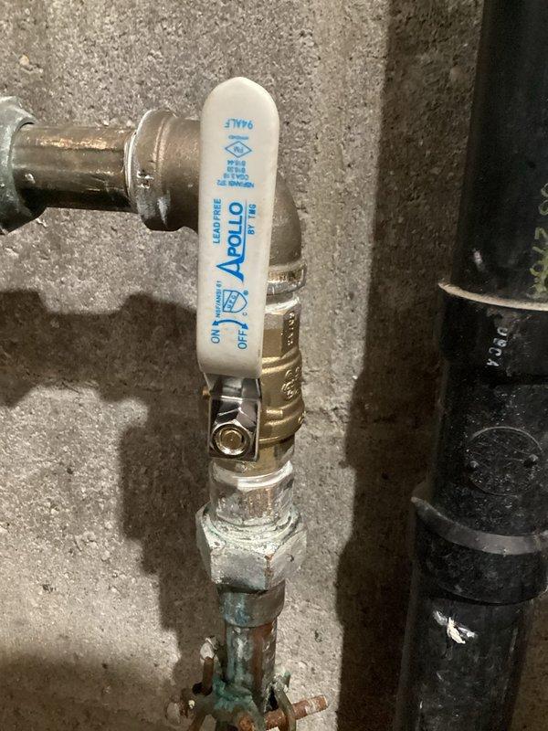 Responded to a water leak in the basement at the main water line connection. Upon inspection, identified a slow leak at the compression nut fitting located before the main shutoff valve. The existing nut had failed to maintain a proper seal, causing water seepage at the connection point. Replaced the defective compression nut with a new fitting to restore a watertight seal. Verified the Apollo ball valve assembly and surrounding copper piping for additional issues. Tested the repair under full water pressure to confirm the leak was eliminated and all connections were secure.