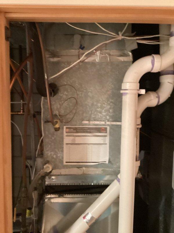 Completed annual spring cooling tune-up on older AC system and air exchanger unit. AC system is currently operational but found to be low on refrigerant charge; recommended planning for system replacement in near future. Air exchanger unit exhibiting multiple critical issues including motor slow-start condition with excessive noise and heat buildup, deteriorating filters that are difficult to clean, missing condensate drain line causing water discharge directly onto floor, and improper exhaust configuration venting stale air back into living space. Verified furnace filter recently changed and humidifier properly shut down for cooling season. Strongly recommended priority replacement of air exchanger due to compromised performance and improper drainage/ventilation configuration.