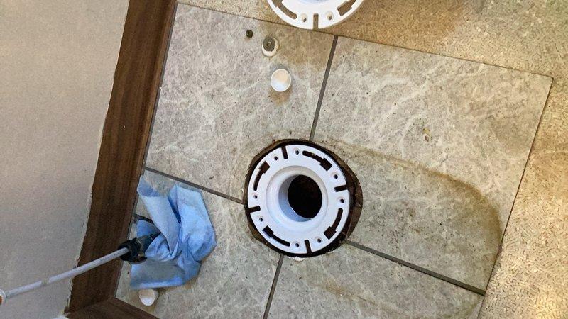 Responded to water leak originating from bathroom main line with visible ceiling damage. Upon inspection, identified failed cast iron closet flange as source of leak. Installed cast iron closet repair flange and properly reset toilet to restore functionality and eliminate water intrusion. Documentation photos captured pre-repair conditions and completed flange installation.