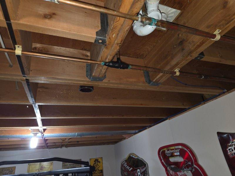 Responded to multiple copper pipe leaks in residential plumbing system, including critical leak near pressure tank dripping onto electrical components. Conducted comprehensive inspection of all affected areas and documented conditions with photographs. Reviewed all leak locations with homeowner and assessed system condition, noting exposed copper piping in ceiling joists and pressure tank connections requiring attention. Coordinated estimate for complete repipe and new pressure tank tee with accessories to address systemic issues and prevent future failures.