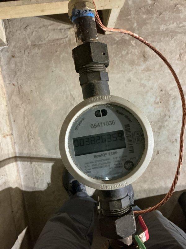 Responded to callback regarding elevated water consumption following recent water filtration system installation. Customer reported water bill increased from typical 2,500 gallons to 4,000 gallons monthly, with visible leaking from red tubing on RO system drain line. Inspected water filtration equipment and identified excessive regeneration cycle frequency as primary cause of increased water usage. Adjusted regeneration schedule from 7-day intervals to 14-day intervals and reduced water volume used during regeneration cycles. Verified Kamstrup flowIQ 2100 water meter readings and documented current consumption. Addressed RO system drain line leak and confirmed proper operation of filtration equipment after adjustments.