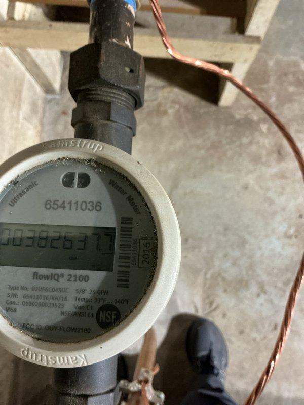 Responded to callback regarding elevated water consumption following recent water filtration system installation. Customer reported water bill increased from typical 2,500 gallons to 4,000 gallons monthly, with visible leaking from red tubing on RO system drain line. Inspected water filtration equipment and identified excessive regeneration cycle frequency as primary cause of increased water usage. Adjusted regeneration schedule from 7-day intervals to 14-day intervals and reduced water volume used during regeneration cycles. Verified Kamstrup flowIQ 2100 water meter readings and documented current consumption. Addressed RO system drain line leak and confirmed proper operation of filtration equipment after adjustments.