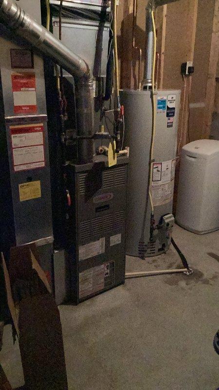 Responded to no hot water condition caused by failed gas valve on existing water heater. Removed and properly disposed of original unit. Installed new 50-gallon natural gas standard vent water heater in basement mechanical room in place of like unit. Connected yellow flexible gas line, white PVC venting, and all water supply lines per code. Verified proper clearances from furnace and other mechanical equipment. Tested all connections for leaks, confirmed proper venting operation, and verified hot water delivery throughout residence. Permit obtained and installation completed to current plumbing code requirements.
