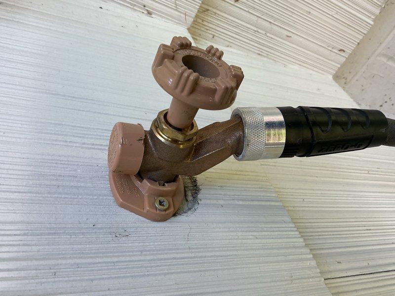 Responded to a leak complaint on a recently replaced outdoor spigot that was dripping from the packing nut behind the handle when a hose was connected. Upon inspection, determined the packing nut had loosened during normal operation. Tightened the packing nut to proper torque specification, resolving the leak completely with no additional repairs required.