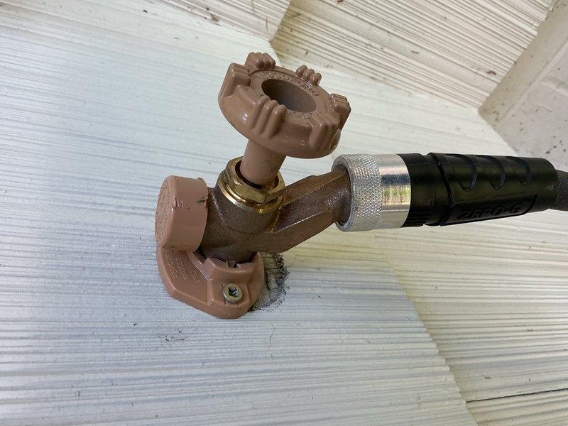 Responded to a leak complaint on a recently replaced outdoor spigot that was dripping from the packing nut behind the handle when a hose was connected. Upon inspection, determined the packing nut had loosened during normal operation. Tightened the packing nut to proper torque specification, resolving the leak completely with no additional repairs required.