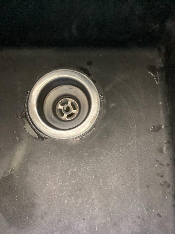 Responded to clogged kitchen sink with drainage issues. Upon inspection, found dual-basin sink with standing water and confirmed blockage in drain line. Successfully cleared obstruction using cable snake equipment through the drain assembly. Verified proper drainage flow restored to both basins and confirmed P-trap connections under sink were secure with no active leaks detected at time of service completion.