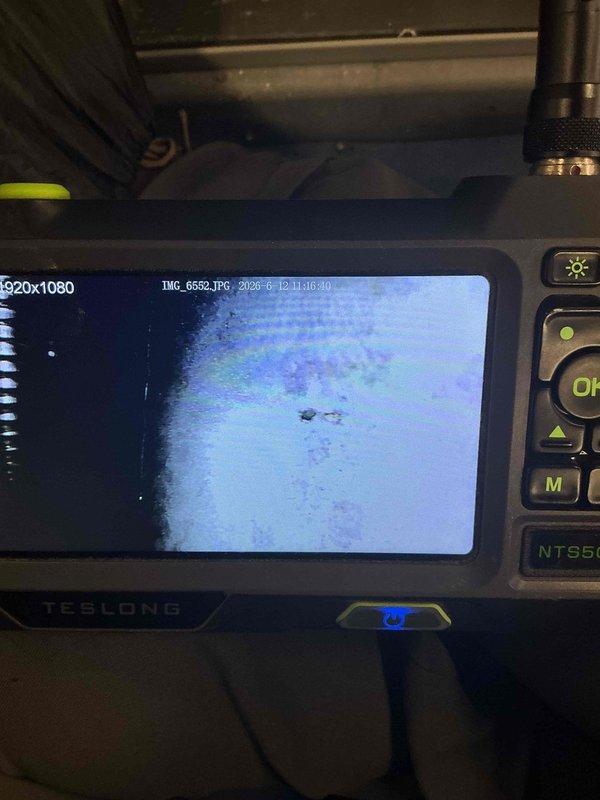 Responded to no cool call on 12-year-old ICP air conditioning system with indoor temperature maintaining 77-80 degrees. Upon arrival, performed comprehensive diagnostic evaluation of the cooling system.

Conducted airflow verification procedures including filter inspection, evaporator coil assessment, and blower speed confirmation. All airflow components found to be operating within acceptable parameters with no restrictions identified.

Performed refrigerant charge analysis on R410A system with total capacity of approximately 7 pounds. Diagnostic testing revealed system operating with significant refrigerant loss of approximately 3 pounds, indicating active leak in refrigerant circuit. Low refrigerant charge confirmed as primary cause of inadequate cooling performance.

During system inspection, utilized borescope camera equipment to conduct internal examination of furnace heat exchanger. Visual inspection revealed compromised heat exchanger with visible perforation, presenting potent