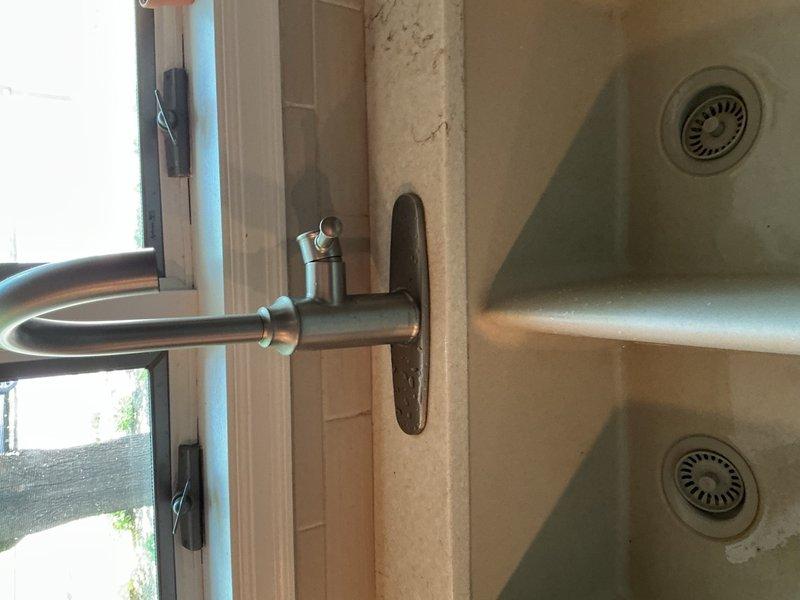 Installed customer-supplied Kohler kitchen sink faucet, ensuring proper mounting and connection to water supply lines. Repaired leaking hose bibb shut-off valve in basement by tightening the packing gland to stop dripping. Tested all fixtures upon completion to verify proper operation with no leaks present.