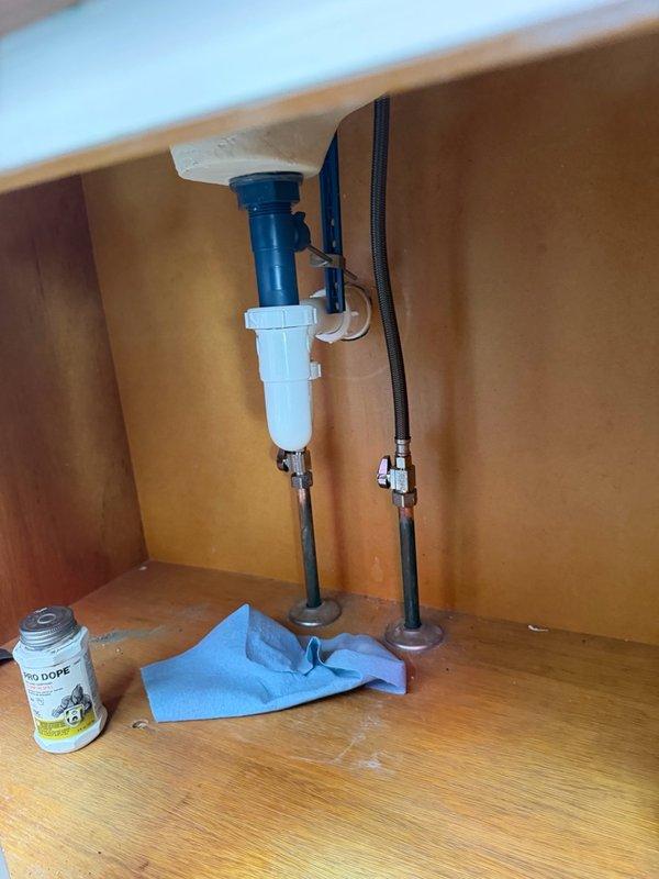 Installed two customer-supplied bathroom faucets in upstairs bathrooms. Removed existing faucets, connected new chrome two-handle faucet assemblies with supply lines and drain assemblies, and tested for proper operation and leaks. All fixtures are functioning correctly with no visible leaks at connections.