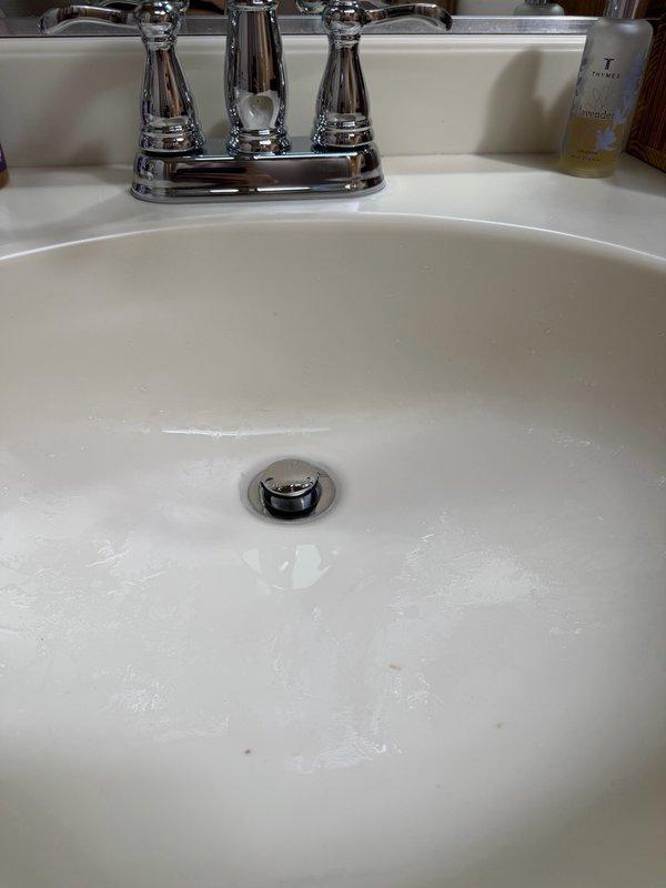 Installed two customer-supplied bathroom faucets in upstairs bathrooms. Removed existing faucets, connected new chrome two-handle faucet assemblies with supply lines and drain assemblies, and tested for proper operation and leaks. All fixtures are functioning correctly with no visible leaks at connections.