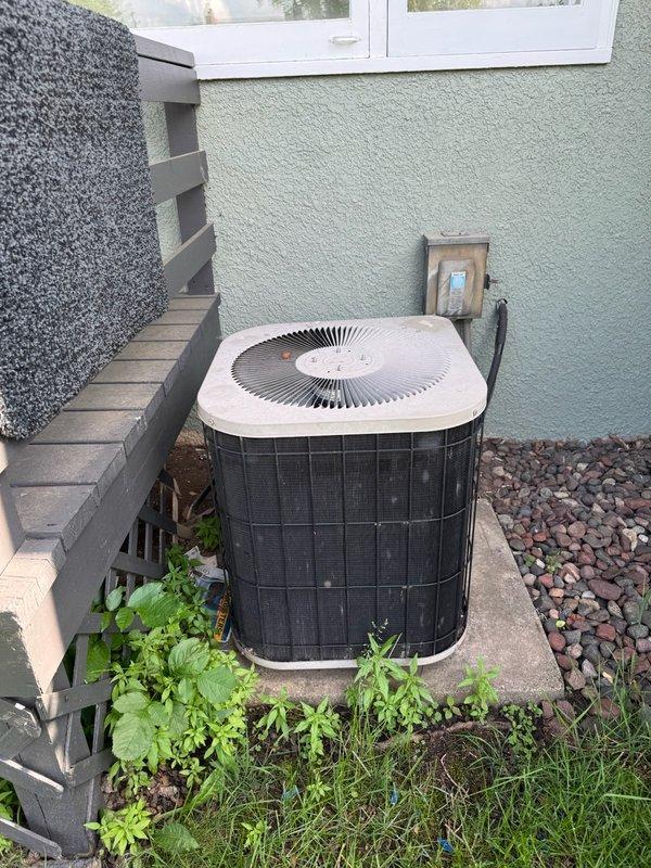 Responded to no cooling complaint on 20-year-old residential HVAC system where outdoor condenser fan was operating but inadequate cooling was present. Upon inspection and diagnostic testing, found system critically low on refrigerant charge. Due to age of equipment and extent of refrigerant loss indicating likely leak, recommended full system replacement rather than repair given that unit has exceeded typical service life expectancy and would require significant investment in obsolete components.