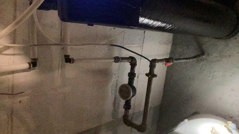 Responded to continuous water leak originating from water heater in lower electrical panel area. Upon inspection, identified active leak from bottom element panel indicating compromised tank integrity. Water heater showed significant age-related deterioration with visible rust staining, corrosion at base, and moisture damage on surrounding concrete floor. Tank failure determined to be non-repairable due to structural compromise. Recommended and scheduled complete water heater replacement to resolve leak and restore hot water system functionality.