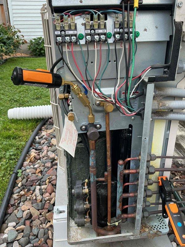 Responded to no cooling complaint on aging mini-split system that was not adequately cooling home or controlling humidity. Upon inspection, found refrigerant level low in outdoor unit. Performed refrigerant recovery, evacuated system with vacuum pump, and recharged to manufacturer specifications. Customer advised that unit has not received regular maintenance and is considering central air conditioning system as alternative solution for improved whole-home comfort and humidity control.