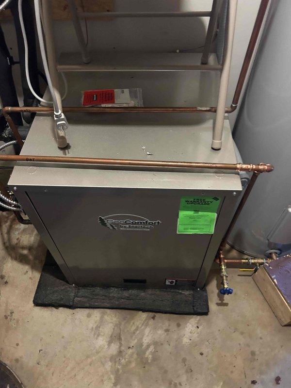 Responded to service call for geothermal system with domestic hot water issue. Coordinated with plumbing contractor who had restored cold water supply but was unable to complete hot water repairs. Performed repairs on geothermal loop system by replacing flanged plate, tension ring, and mounting bolts. Bled air from domestic hot water lines and geothermal loop lines to ensure proper system operation. Conducted system tests to verify equipment functionality. System restored to proper operation with both heating loop and hot water supply functioning correctly.