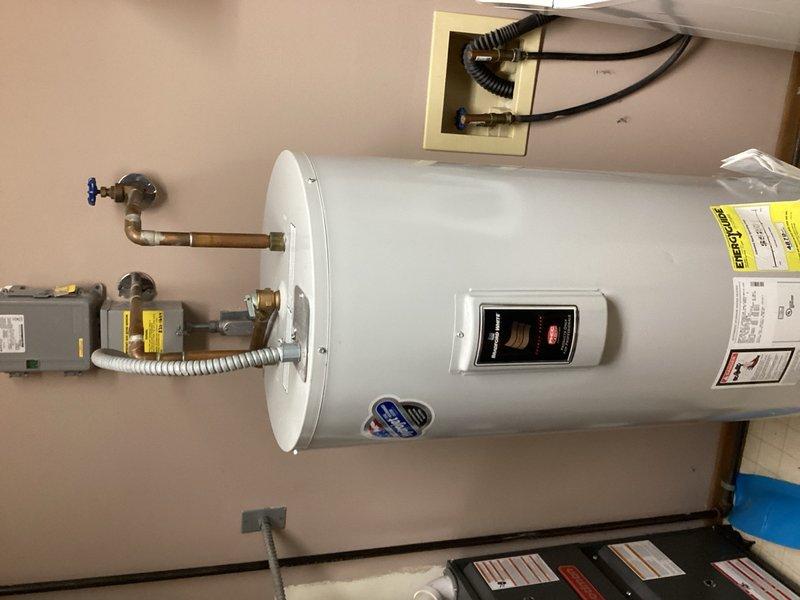 Responded to service call for 50-gallon electric water heater leaking from the bottom with visible water on floor. Upon inspection, determined unit had failed and required full replacement due to tank breach. Removed and properly disposed of old 50-gallon electric water heater. Installed new 50-gallon electric water heater unit with appropriate copper piping connections, shut-off valves, and electrical connections. Tested unit for proper operation, verified all connections for leaks, and confirmed thermostat functionality. Left installation manuals and documentation with property.