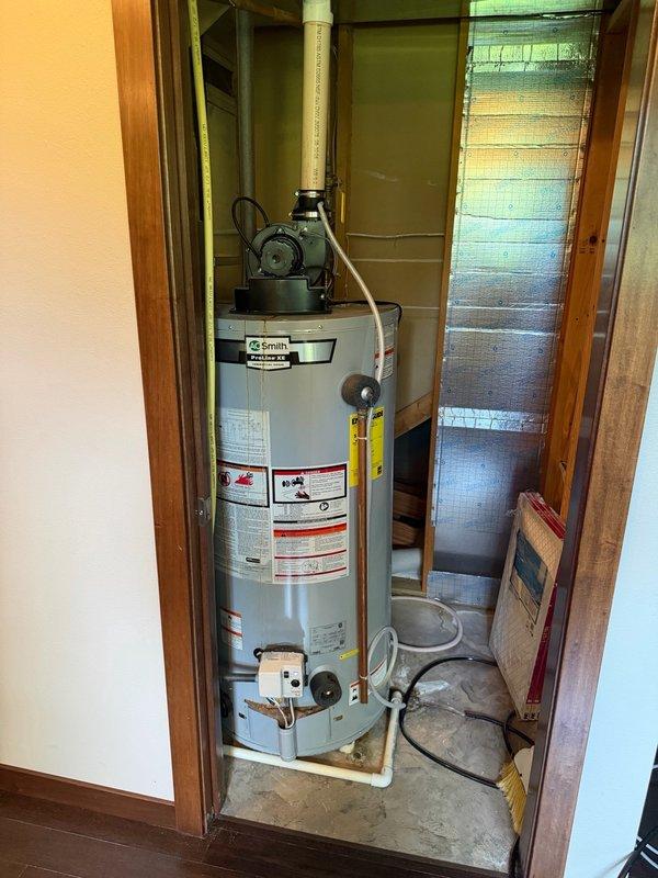 Responded to no hot water complaint on 50-gallon power vent natural gas water heater. Upon arrival, found unit cycling vent motor but failing to heat water. Discovered thermostat set to 160°F, which likely caused thermal cut-off (TCO) to trip. Identified significant corrosion on inlet and outlet connection ports allowing water intrusion into pressure switch port, compromising unit operation. Reset TCO and restored hot water functionality. Adjusted thermostat setting down to recommended 120°F to prevent future overheating issues. Documented corrosion damage with photographs showing deteriorated pipe connections and mineral buildup on tank top. Provided replacement estimates to homeowner due to advancing corrosion and compromised water heater integrity. Coordinated follow-up appointment for acid neutralizer system evaluation to address potential water chemistry issues contributing to accelerated corrosion.