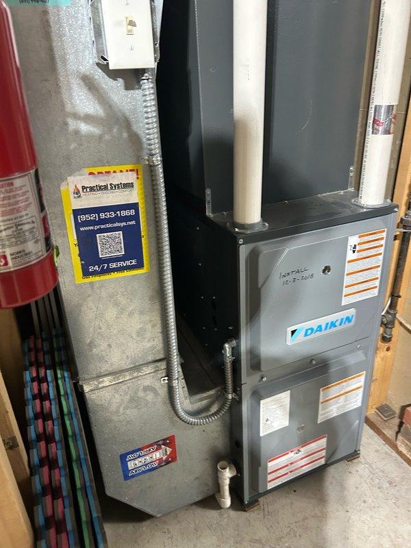 Completed spring AC tune-up as part of the Practical Advantage Maintenance Membership on a 7-year-old Daikin system. Performed comprehensive maintenance inspection including thermostat operation verification, air filter condition assessment, blower assembly inspection, outdoor coil examination, and electrical component testing. Checked contactor, capacitor, and condensate drain line for proper operation. Measured refrigerant circuit pressures using diagnostic gauges and evaluated temperature split across the evaporator coil.

System confirmed operational with all components functioning. Thermostat responding correctly to temperature calls. Blower assembly operating smoothly without unusual noise or vibration. Outdoor coil clean with adequate airflow. Electrical connections secure with proper voltage readings. Contactor engaging properly and capacitor within acceptable microfarad range. Condensate drain flowing freely without restrictions.

However, gauge readings indicated a slightly l