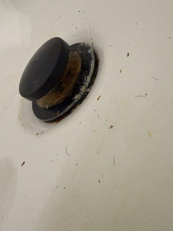 Responded to a bathtub leak causing water damage to the ceiling below. Upon inspection, identified that the drain stopper had been cross-threaded into the waste pipe, creating an improper seal and allowing water to escape. Removed the inlet pipe assembly, cleaned the threads, and properly reinstalled and resealed the stopper to eliminate the leak. Tested the drain system to confirm proper operation and verify no further water intrusion.
