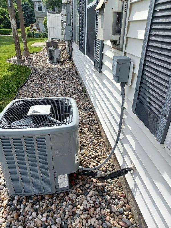 Performed comprehensive AC tune-up on Daikin condensing unit. Inspected indoor air handler, confirmed filter in good condition, and verified drain line clear and draining properly. Measured temperature split at 15.4°F across the system. Cleaned condenser coils on outdoor unit and inspected all major electrical components, with capacitor and contactor testing within normal operating range. During refrigerant circuit evaluation under 76°F ambient conditions with direct sunlight on condenser, system appears to be undercharged. Customer will contact utility provider regarding potential electrical concerns before proceeding with refrigerant service.