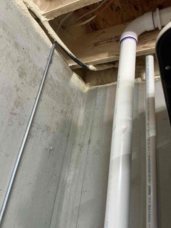 Completed gas line assessment for residential property with existing underground gas lines requiring connection to fireplace and grill appliances. Inspected basement utility area where new gas line attachment point was identified at home connection. Verified existing underground gas line infrastructure and evaluated connections for outdoor grill and sink installations. Documented current plumbing configuration including exposed PVC drain lines and determined additional gas line routing required for proper grill connection in outdoor patio area. Recommended licensed plumber verify all gas line connections, pressure regulators, and sizing to ensure compliance with local codes and safety regulations before final hookup of both appliances.