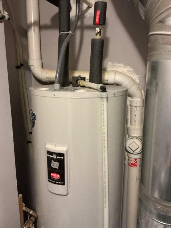 Completed comprehensive AC maintenance tune-up on 10-year-old system equipped with hard start kit. Performed full system inspection, verified proper operation of all components including condenser unit electrical connections and controls, confirmed system functionality, and documented equipment condition with photos showing water heater installation and outdoor condensing unit wiring assembly.