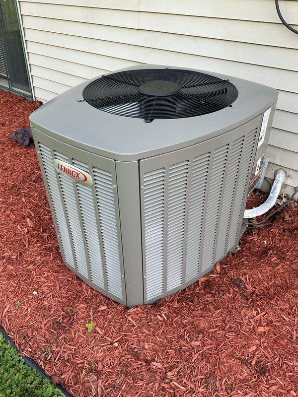 Completed comprehensive AC tune-up on Lennox condensing unit as part of maintenance agreement. Replaced indoor air filter, verified evaporator drain line proper operation, removed condenser panels and thoroughly cleaned condenser coil which showed significant buildup from four years without service. Inspected electrical components including capacitor (within specification) and contactor (good condition). Addressed homeowner concern regarding unusual noise during unit shutdown, identified as refrigerant flow noise due to dirty condenser coil restricting airflow. System startup confirmed proper operation with 22-degree temperature split across evaporator coil, indicating adequate cooling performance and refrigerant charge.