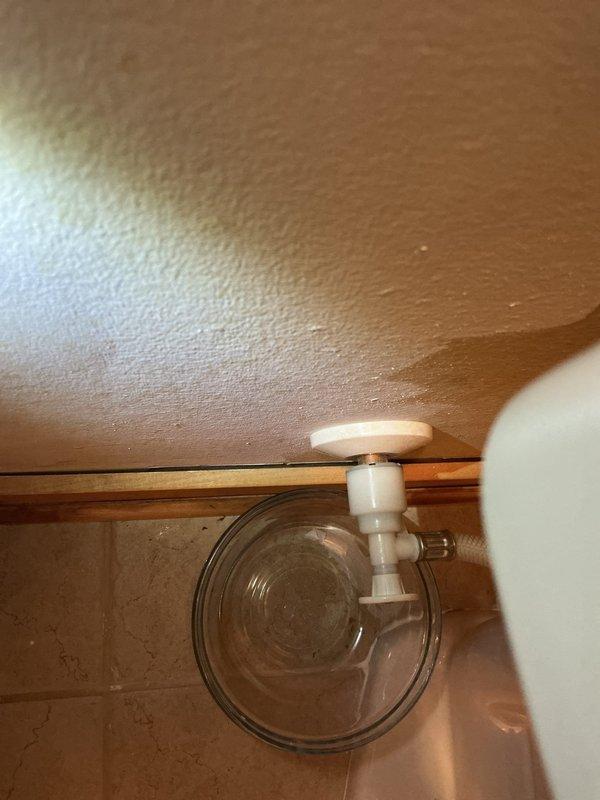 Responded to service call for newly installed toilet with leaking shut-off valve that continued to leak even when closed. Upon inspection, confirmed defective shut-off valve was unable to maintain proper seal. Documented existing water damage on ceiling above fixture indicating ongoing leak issue. Provided estimate for shut-off valve replacement to resolve the leak and prevent further water damage to surrounding areas.