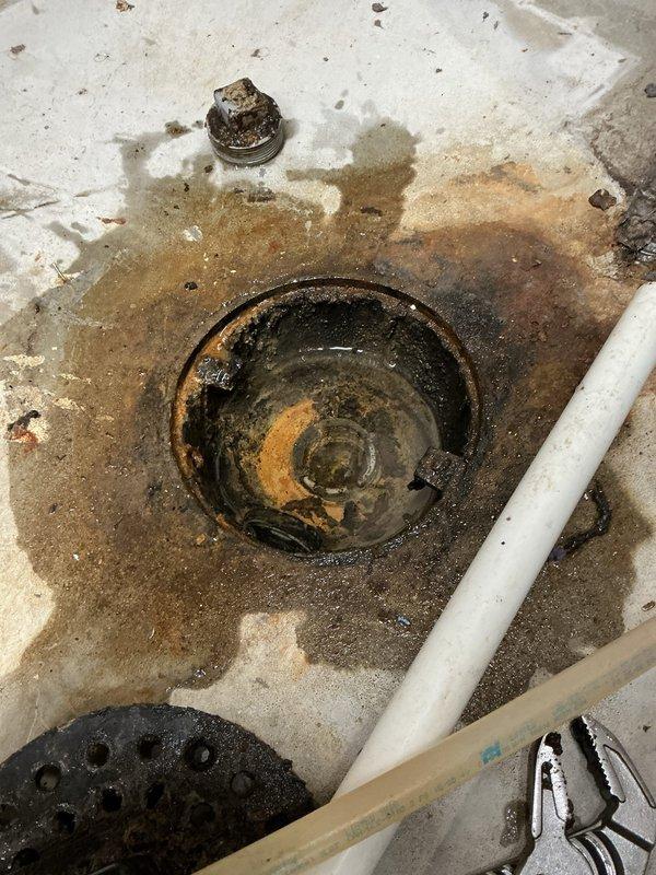 Responded to floor drain backup issue on lower level. Performed diagnostic testing by running water at laundry tub, which caused immediate backup at floor drain. Flushed toilet on same floor with no backup observed, confirming main sewer line was open and blockage was isolated to branch line serving floor drain, laundry, and kitchen.

Cabled both floor drain and laundry drain multiple times using full cable length to clear obstruction. Removed accumulated debris from floor drain using vacuum. Conducted flow test by filling and dumping laundry tub; drainage functioned properly with no backup observed.

Performed camera inspection of floor drain line, identifying minor belly in pipe with standing water that did not impact drainage performance. Scoped main sewer line approximately 30 feet until encountering obstruction at pipe joint. Main line appeared to be plastic pipe in good overall condition. Branch line blockage successfully cleared and normal drainage restored.