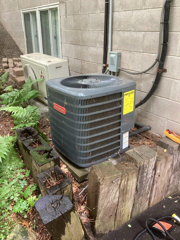 Completed annual AC tune-up and maintenance visit on a Goodman outdoor condensing unit. Performed comprehensive system inspection, verified all components operating within normal parameters, and confirmed unit is clean and in good working condition. Customer reported system has been performing well with no current issues; noted previous condensate drain issue had been previously resolved.