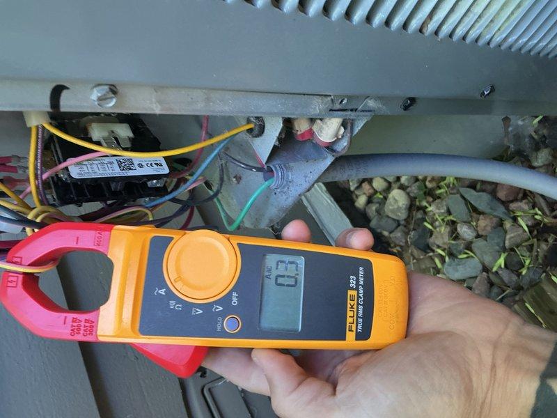 Performed comprehensive AC tune-up maintenance on residential air conditioning system under annual maintenance agreement. Conducted thorough inspection of outdoor condensing unit including rinsing coils, verifying proper refrigerant charge levels using clamp meter for electrical diagnostics, and examining all electrical components, capacitors, and wiring connections. System found operating within normal parameters with no deficiencies noted; all components functioning properly.