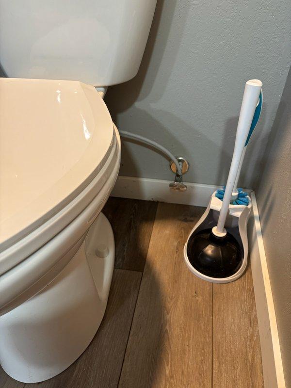 Responded to reported water leaks in bathroom and basement areas. Upon inspection, identified failed wax ring seal at toilet base causing water infiltration at floor-to-wall junction. Removed and reset toilet with new wax ring to restore proper seal and eliminate leak. Inspected basement drainage piping for reported drip from PVC pipe connected to bathroom plumbing system.