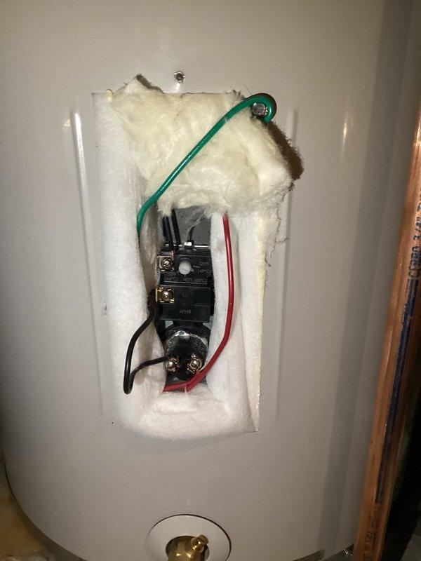 Responded to a no hot water condition on a tanked water heater. Upon arrival, found the thermostat had tripped and was producing a humming noise after reset attempts. Diagnosed faulty thermostat causing repeated tripping. Removed access panel, disconnected power, and replaced the defective thermostat with a new unit. Reconnected all electrical wiring including ground, black, and red wires to proper terminals. Restored power and verified proper operation of the water heater with no abnormal sounds or tripping issues.