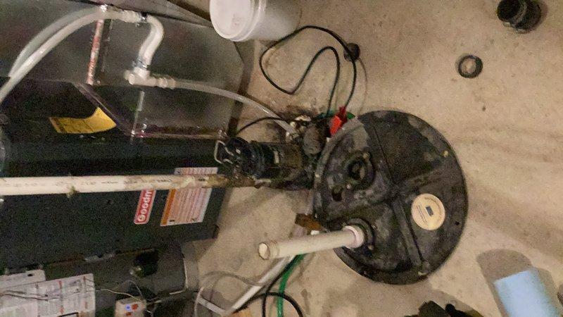 Responded to emergency service call for non-operational sewage pump causing floor drain backup in basement utility area. Upon arrival, assessed failed sewage ejector pump system that had been previously evaluated by drain cleaning team. Removed heavily soiled and inoperative sewage pump from sump basin, which showed significant accumulation of debris and grime indicating system failure. Installed new sewage pump with proper electrical connections and discharge piping configuration. Tested new pump operation to ensure proper functionality and verified discharge flow through existing white PVC piping system. System restored to full operational status with floor drain backup issue resolved.